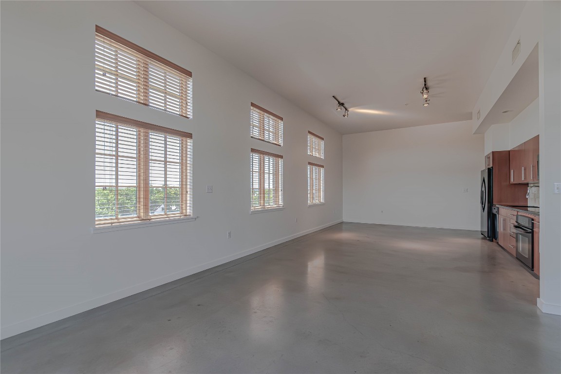 2235 East 6th Street, Unit 404 Austin, TX 78702 - Photo 6 of 37 a view of a livingroom with an empty space and a window
