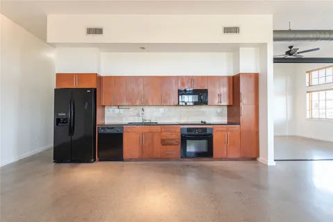 a kitchen with stainless steel appliances granite countertop a refrigerator and a sink