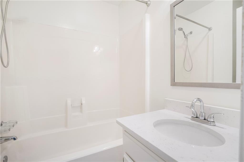 661 North Parkwood Road, Unit C Decatur, GA 30030 - Photo 12 of 14 a bathroom with a sink and a bathtub