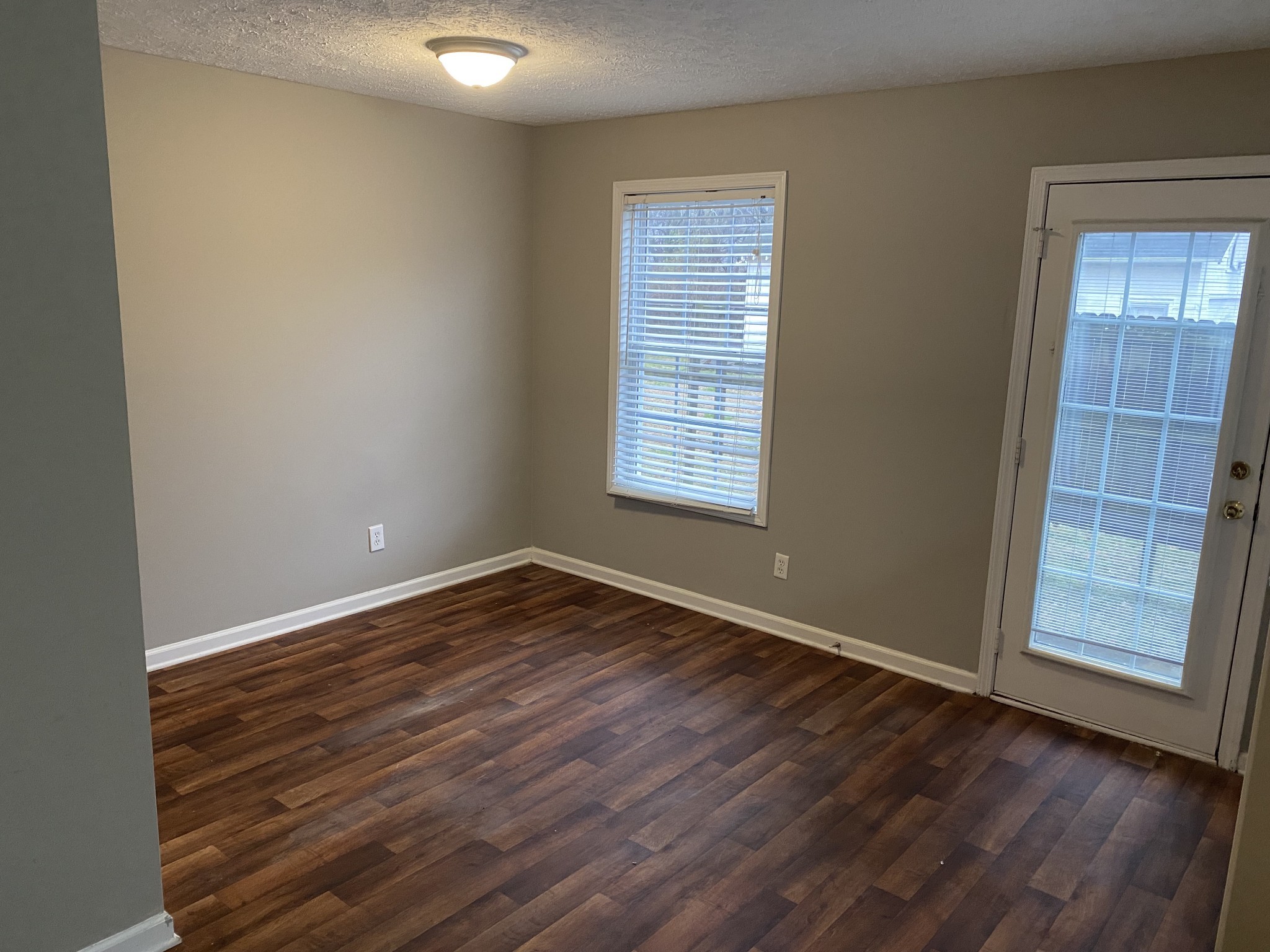 1002 Division Street, Unit 1002 Murfreesboro, TN 37130 - Photo 9 of 15 an empty room with wooden floor and windows