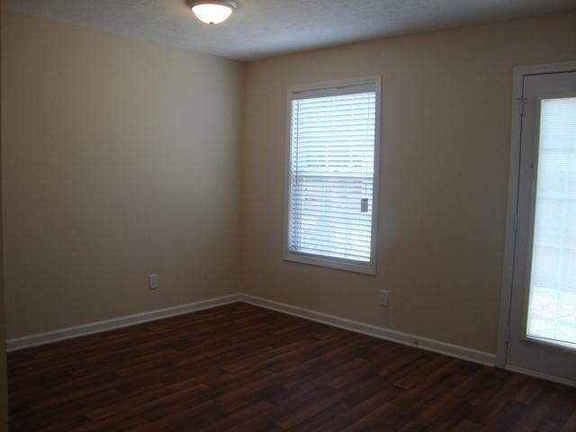 1002 Division Street, Unit 1002 Murfreesboro, TN 37130 - Photo 10 of 15 an empty room with wooden floor and windows