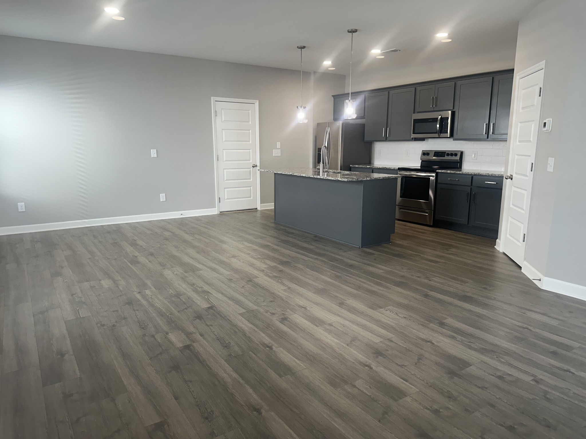 1721 Fenway Loop Antioch, TN 37013 - Photo 5 of 35 a view of kitchen with kitchen island microwave and cabinets