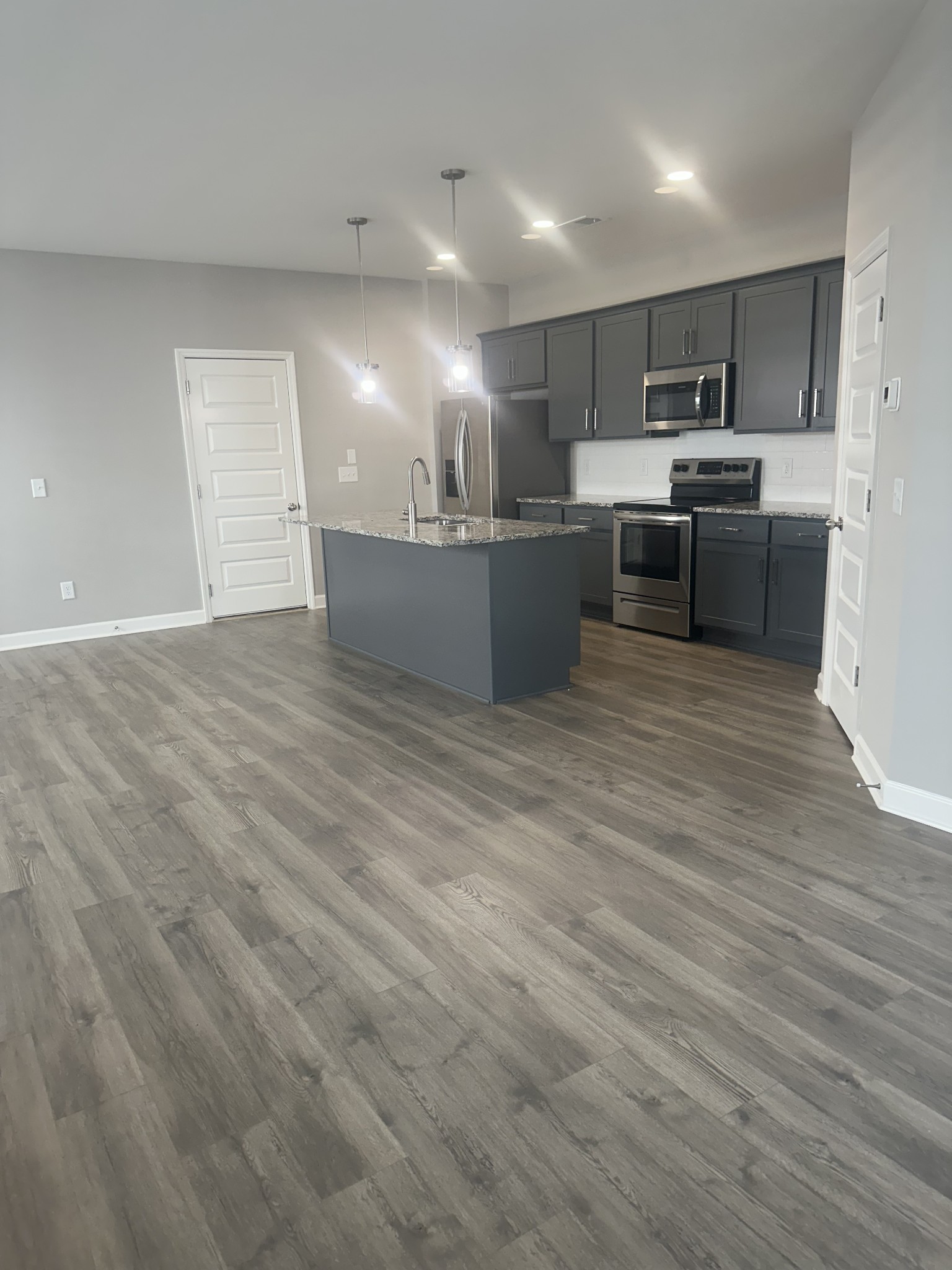 1721 Fenway Loop Antioch, TN 37013 - Photo 6 of 35 a view of kitchen with kitchen island microwave and cabinets