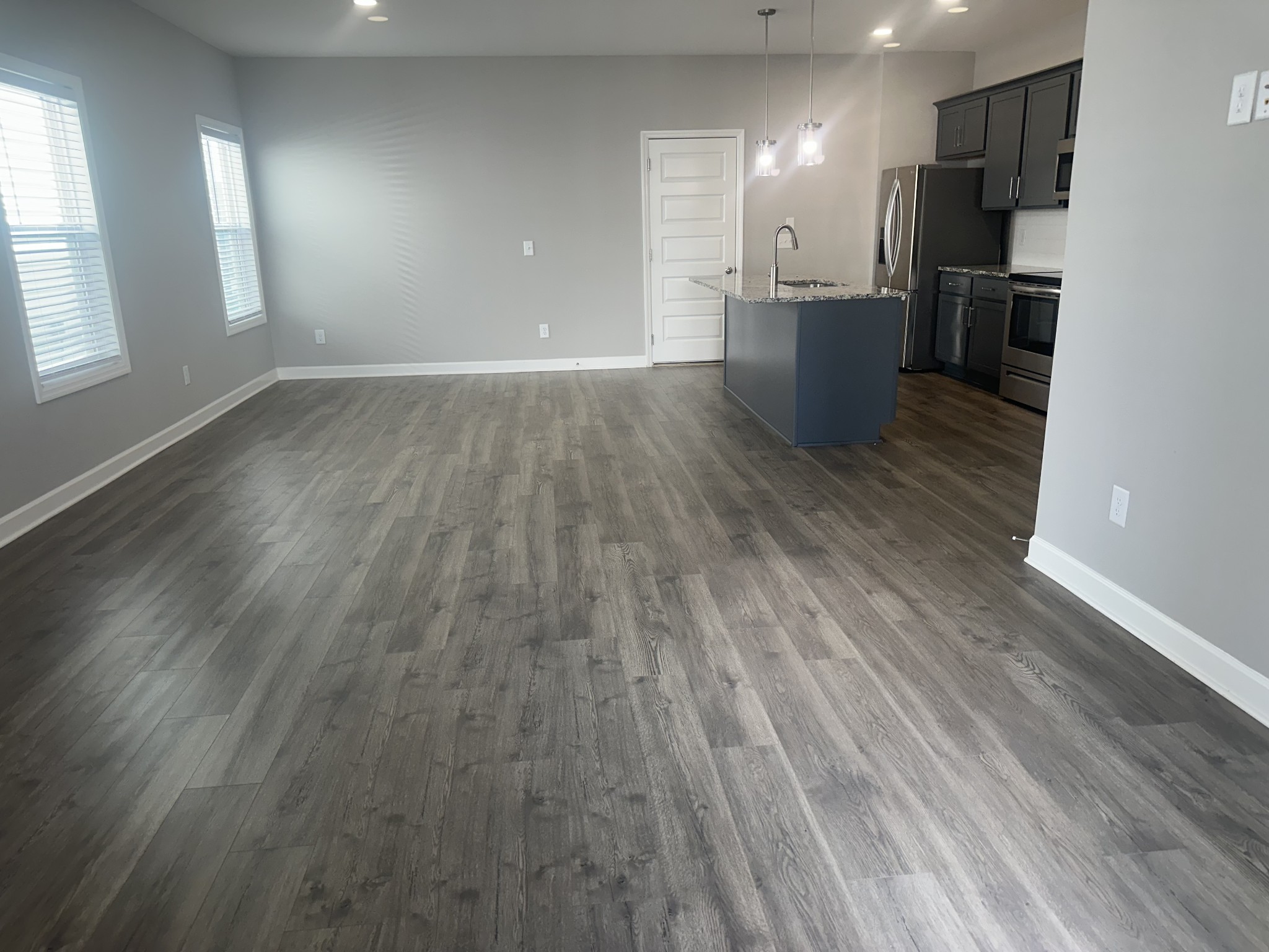 1721 Fenway Loop Antioch, TN 37013 - Photo 7 of 35 an empty room with wooden floor and windows