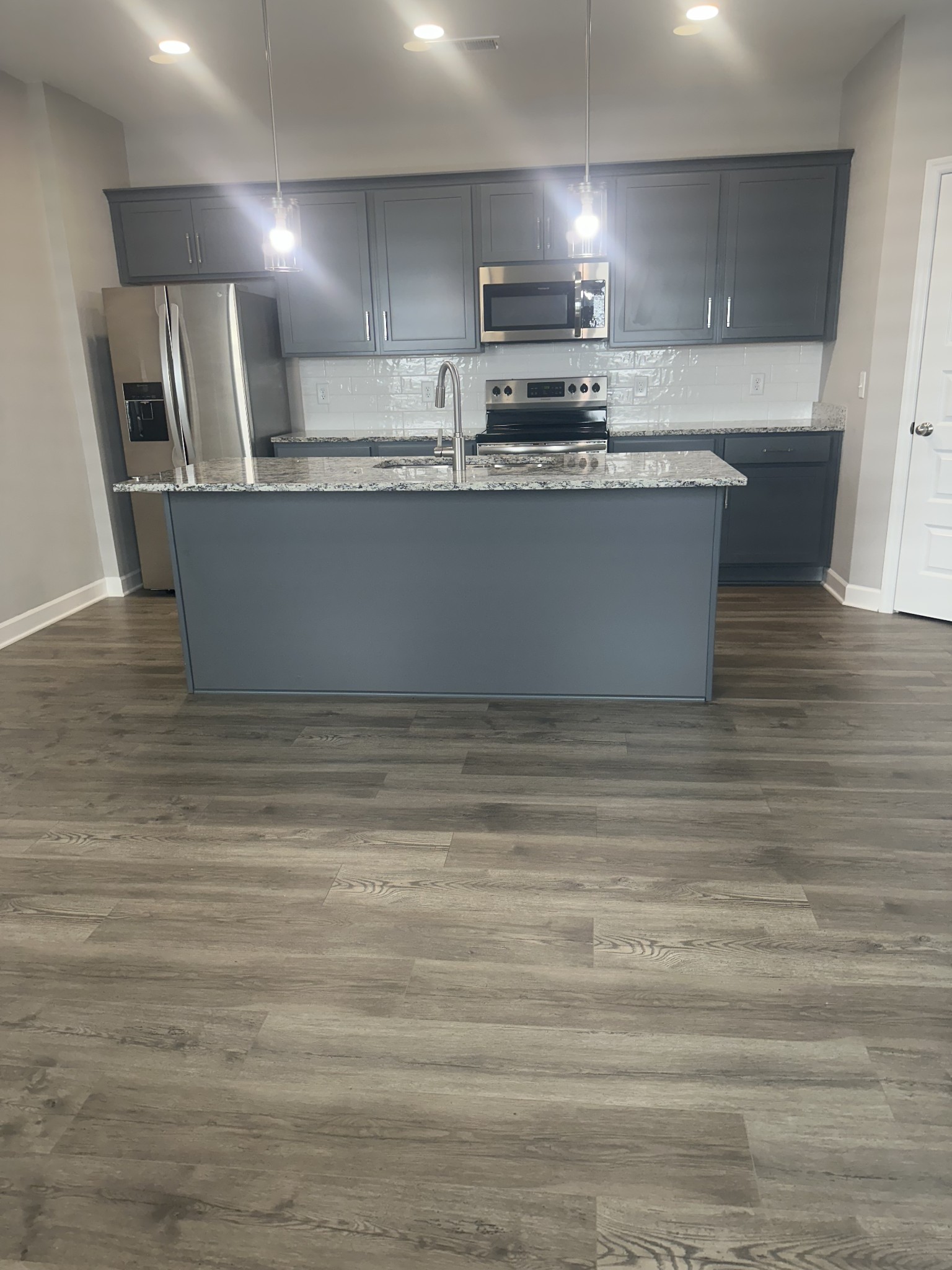 1721 Fenway Loop Antioch, TN 37013 - Photo 8 of 35 a kitchen with kitchen island stainless steel appliances a sink and stove