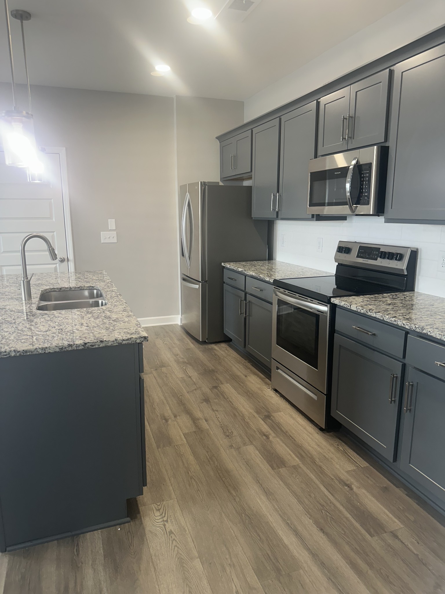 1721 Fenway Loop Antioch, TN 37013 - Photo 10 of 35 a kitchen with stainless steel appliances granite countertop a sink stove and refrigerator