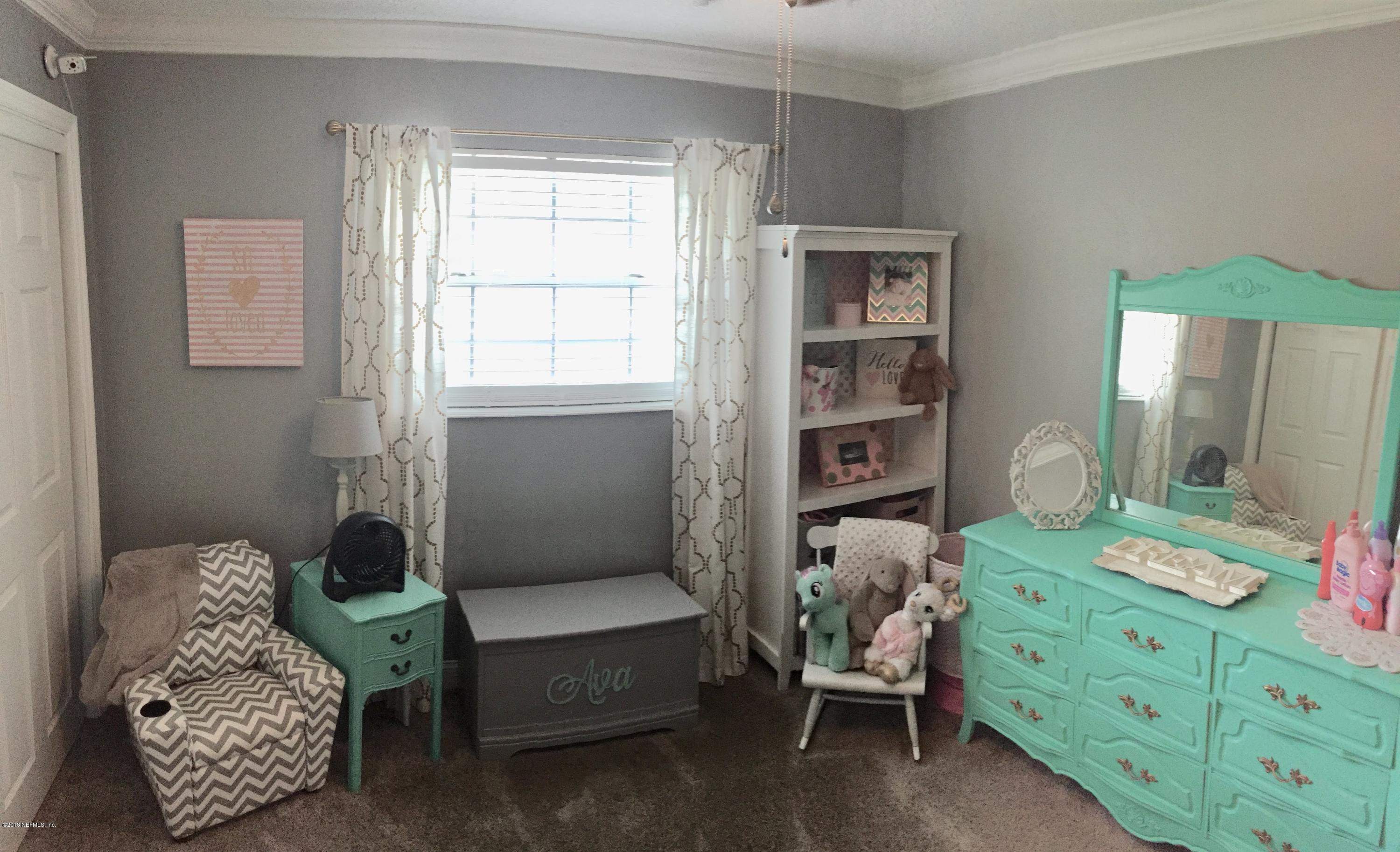 3803 Bess Road Jacksonville, FL 32277 - Photo 15 of 28 a bedroom with a bed and a window