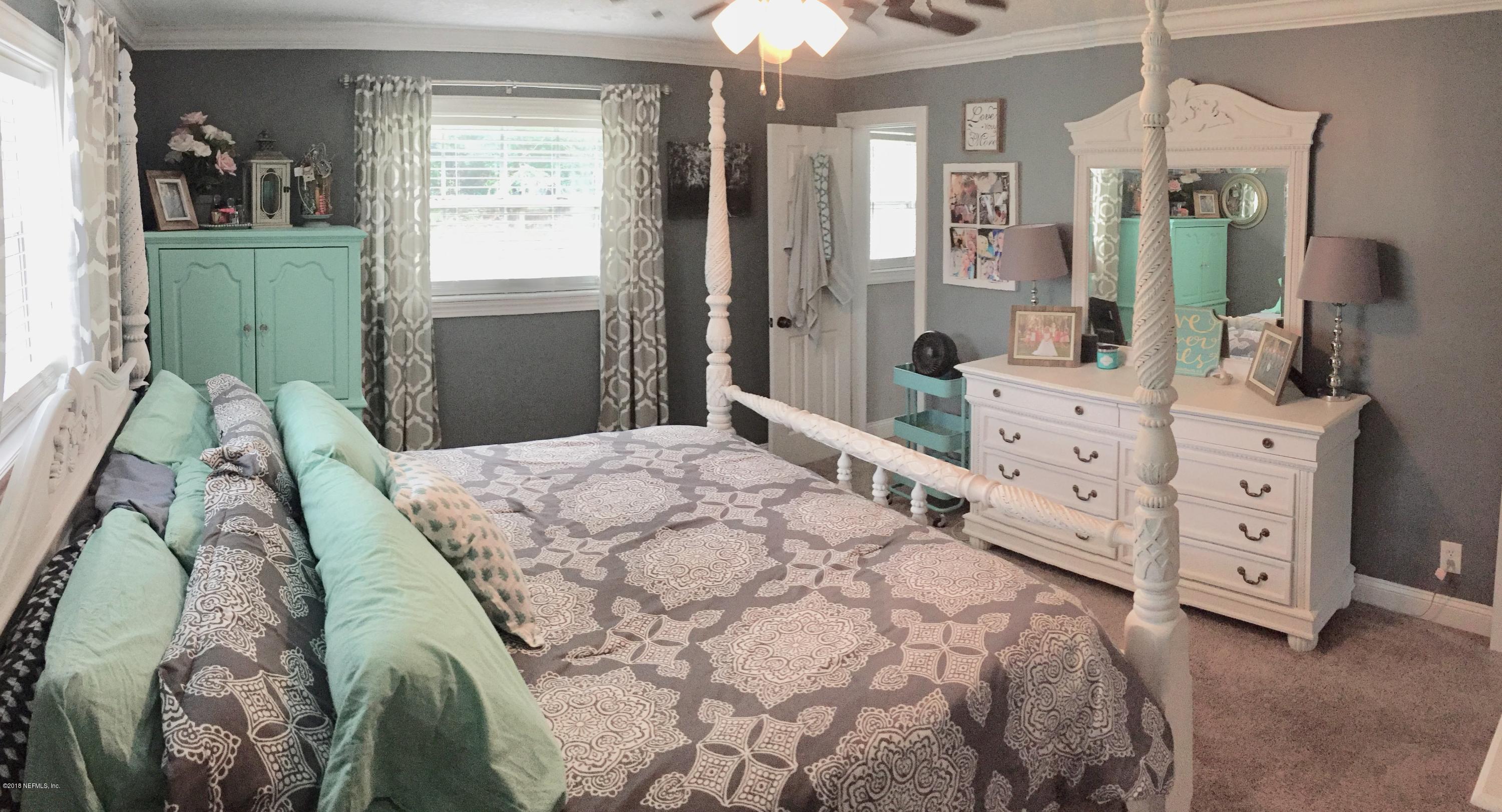 3803 Bess Road Jacksonville, FL 32277 - Photo 18 of 28 a bedroom with a large bed and a dresser