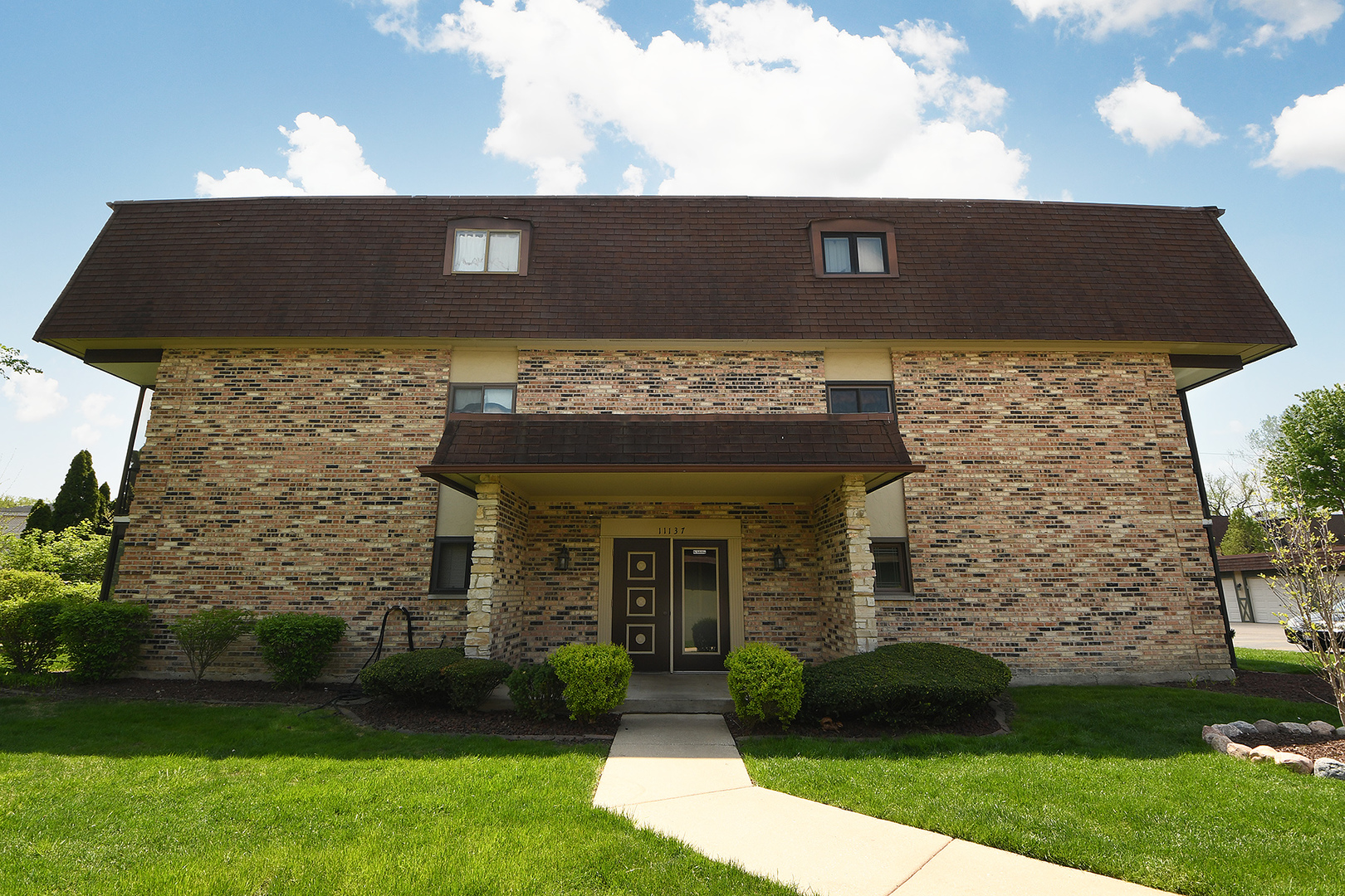 11137 E Road, Unit E Palos Hills, IL 60465 - Photo 1 of 34 a front view of a house with a yard
