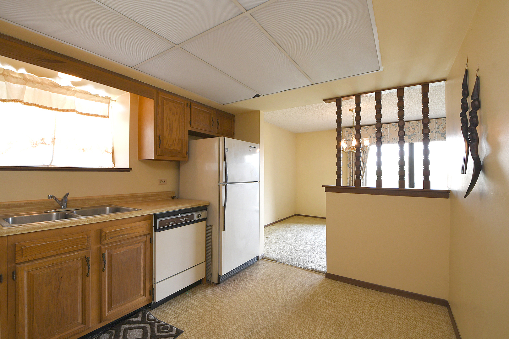 11137 E Road, Unit E Palos Hills, IL 60465 - Photo 12 of 34 a kitchen with a sink a refrigerator and window
