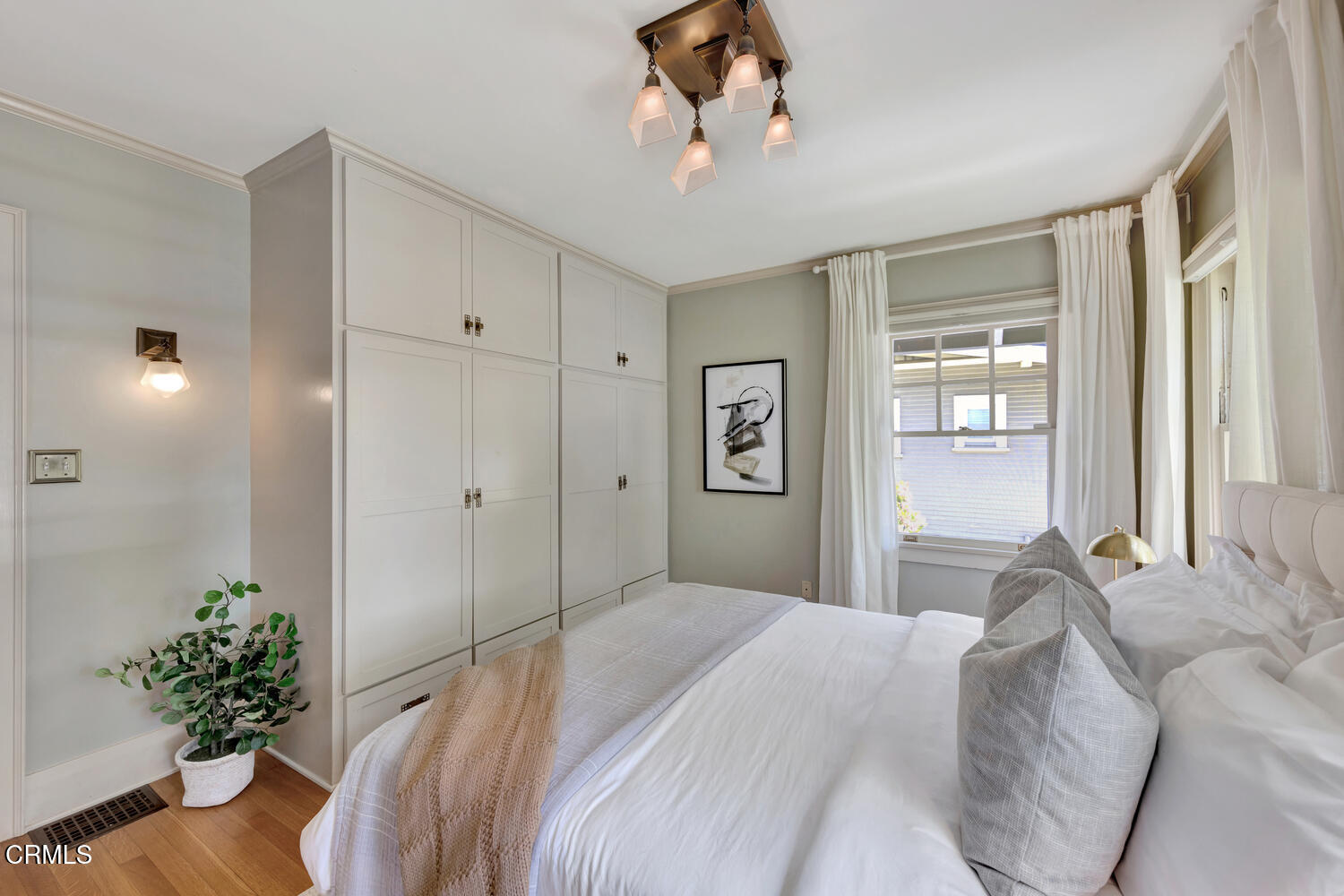 465 Alpine Street Pasadena, CA 91106 - Photo 13 of 45 a bedroom with a large bed chandelier and a window