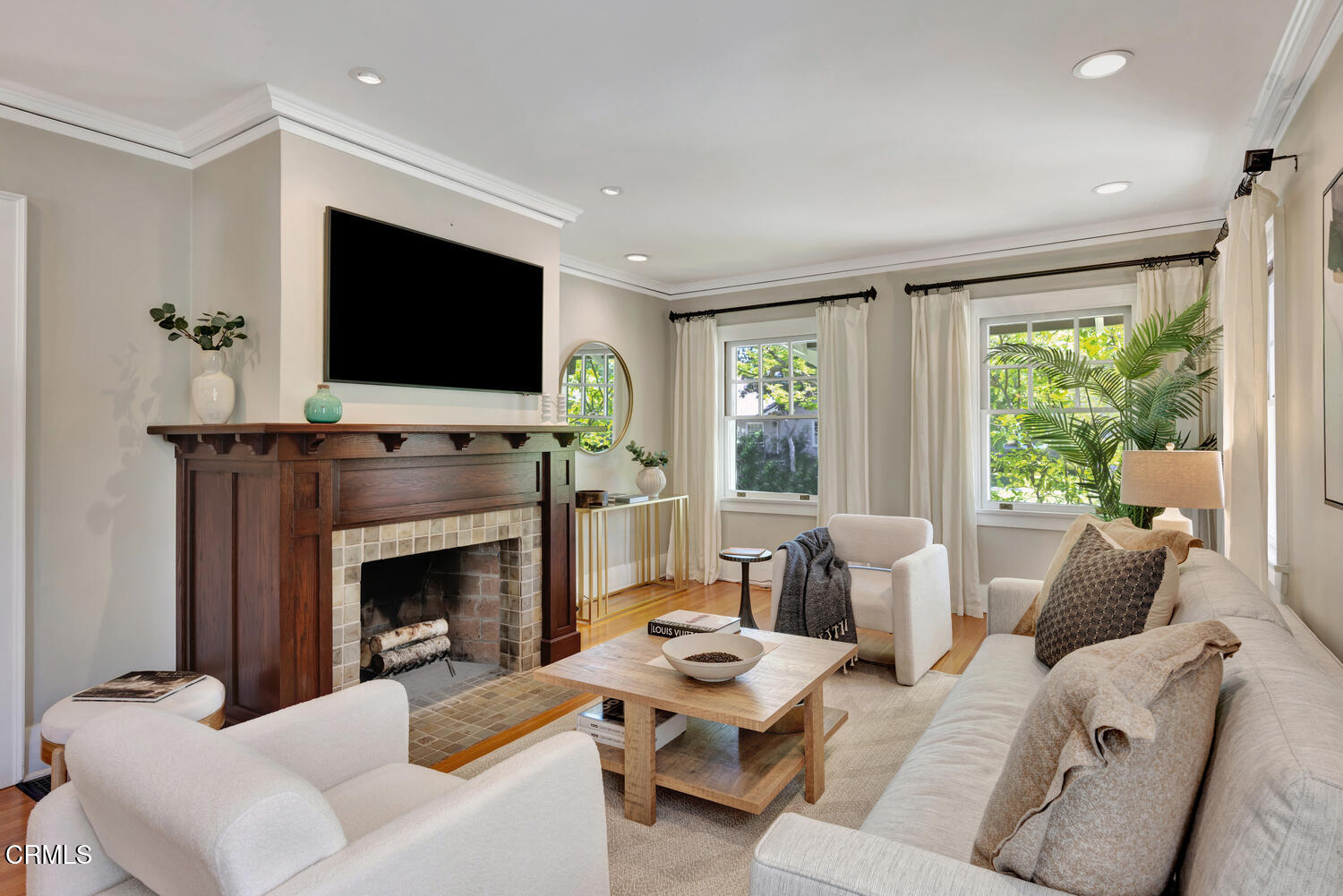 465 Alpine Street Pasadena, CA 91106 - Photo 3 of 45 a living room with furniture a flat screen tv and a fireplace