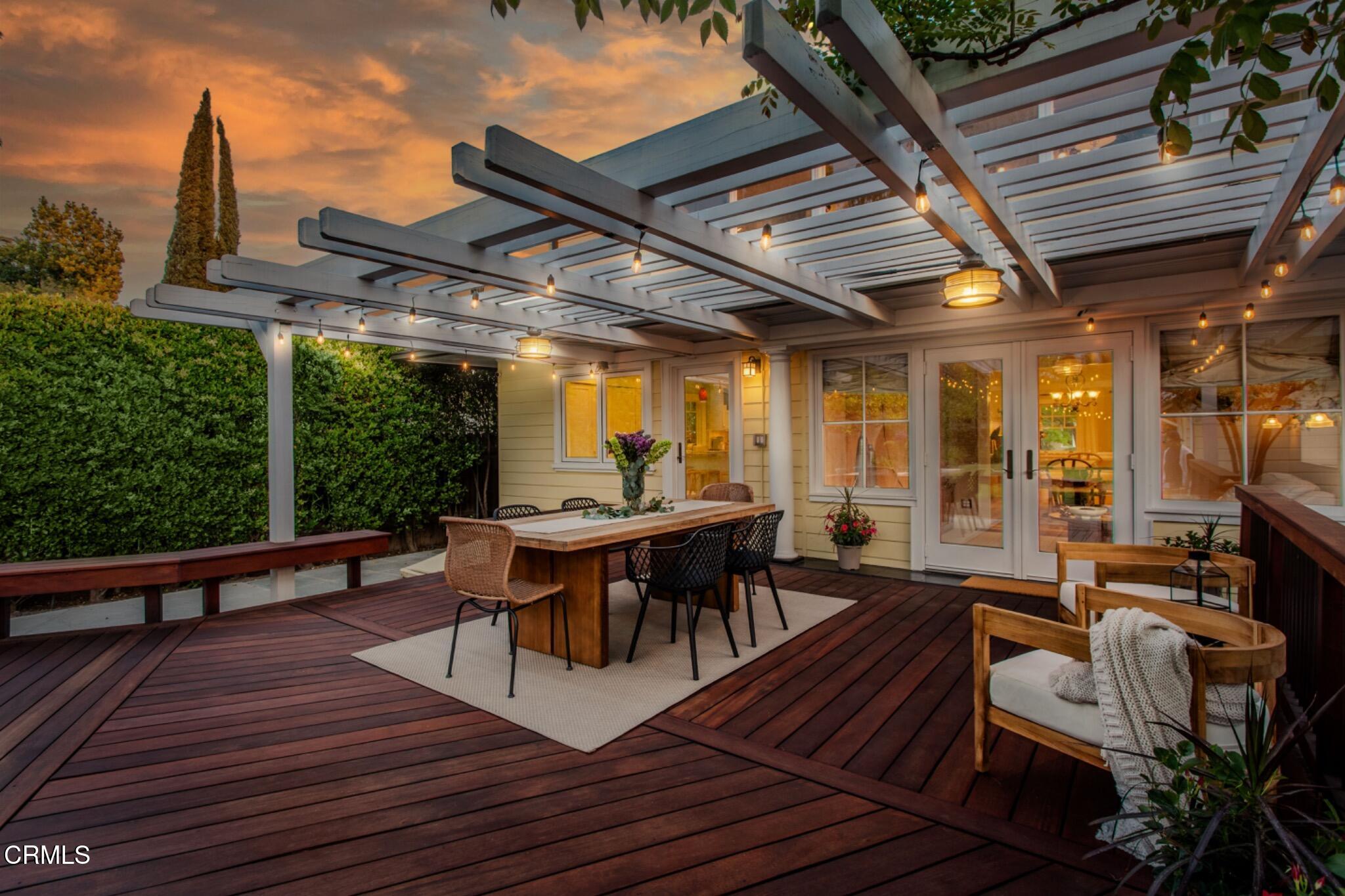 465 Alpine Street Pasadena, CA 91106 - Photo 35 of 45 a view of a patio with table and chairs with wooden floor and fence