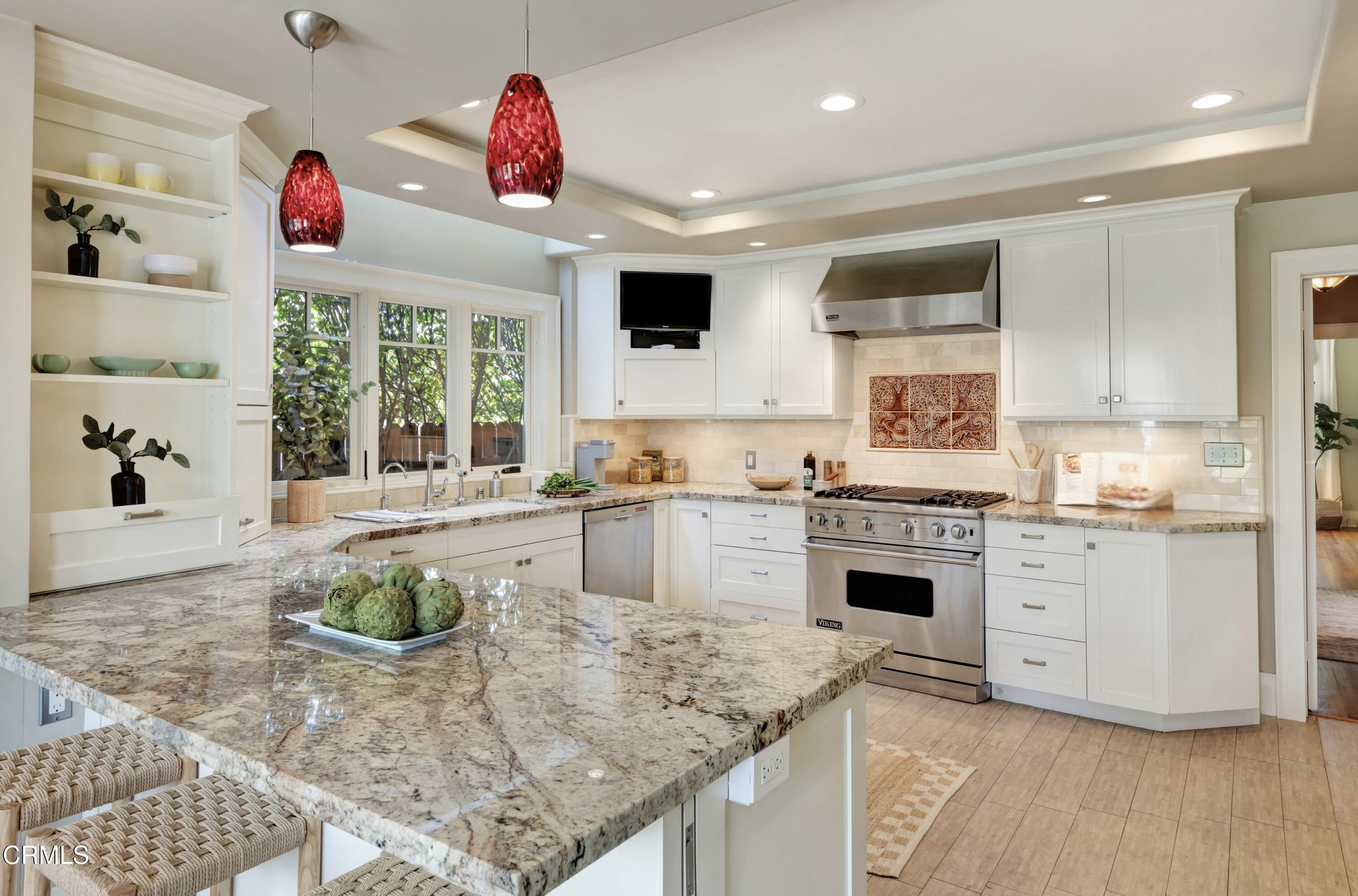465 Alpine Street Pasadena, CA 91106 - Photo 8 of 45 a kitchen with kitchen island granite countertop a stove a sink and dishwasher wooden cabinets with wooden floor