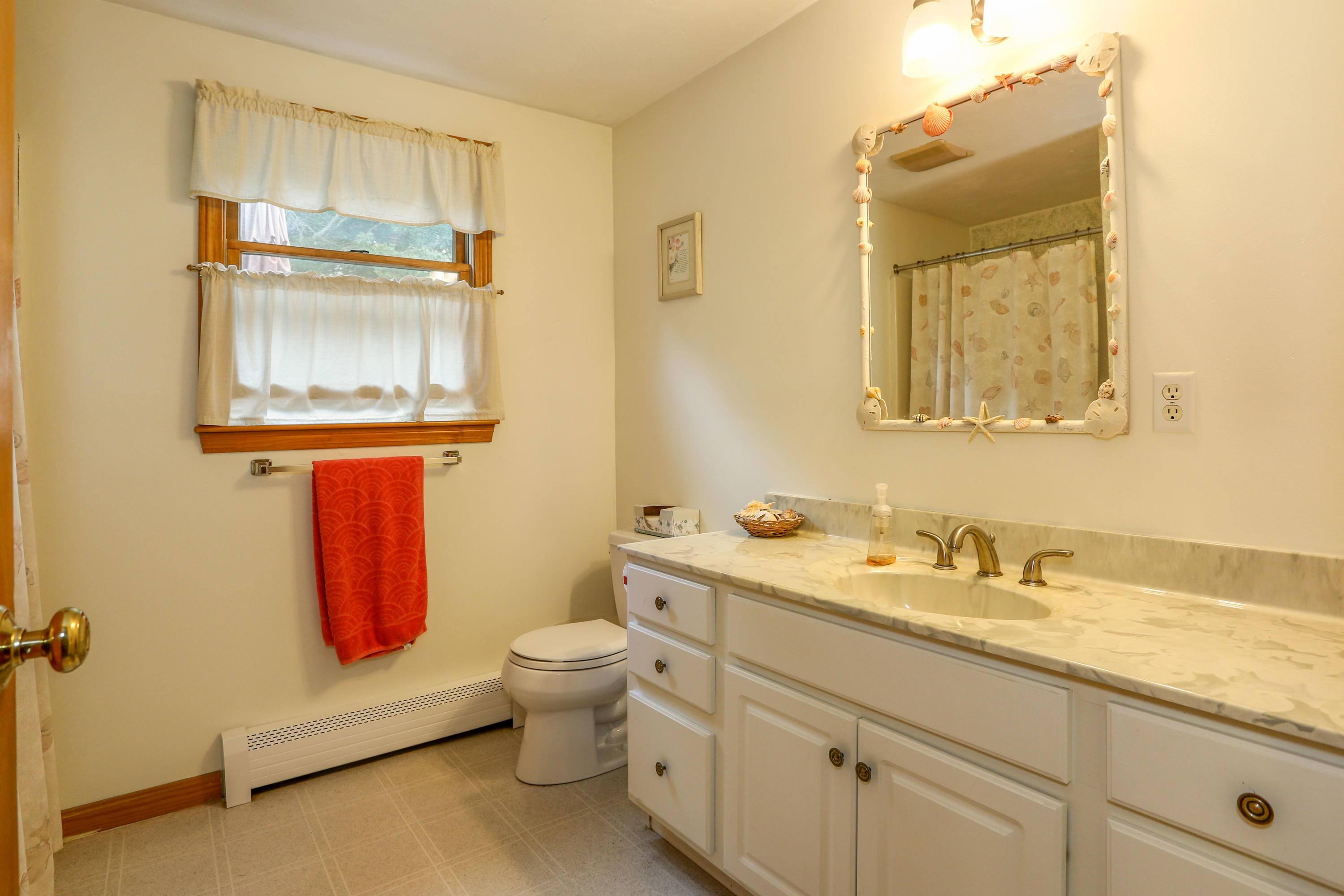3 Andrew Road Sagamore Beach, MA 02562 - Photo 15 of 29 a bathroom with a toilet sink and mirror