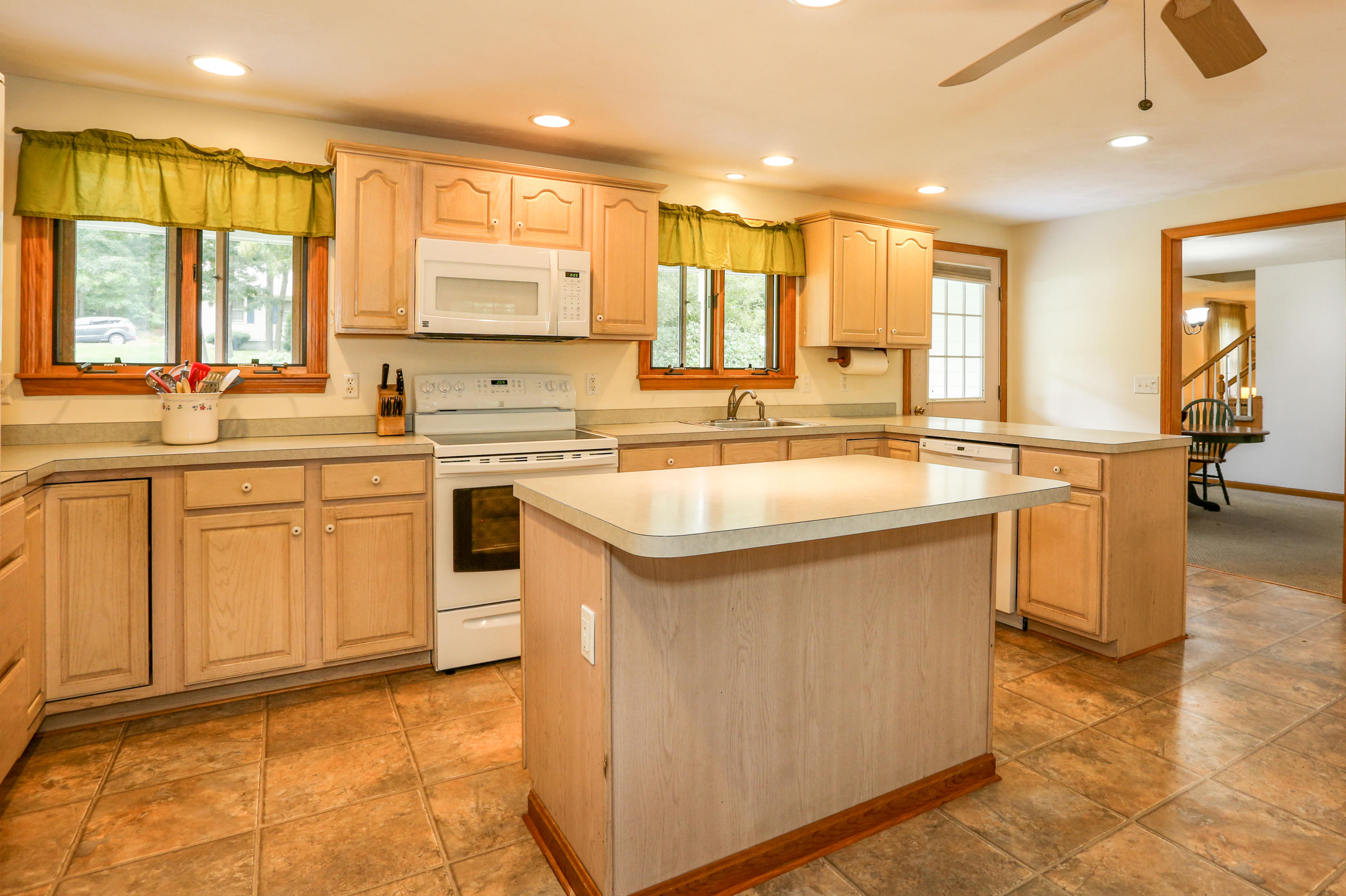 3 Andrew Road Sagamore Beach, MA 02562 - Photo 3 of 29 a kitchen with a sink stove and cabinets