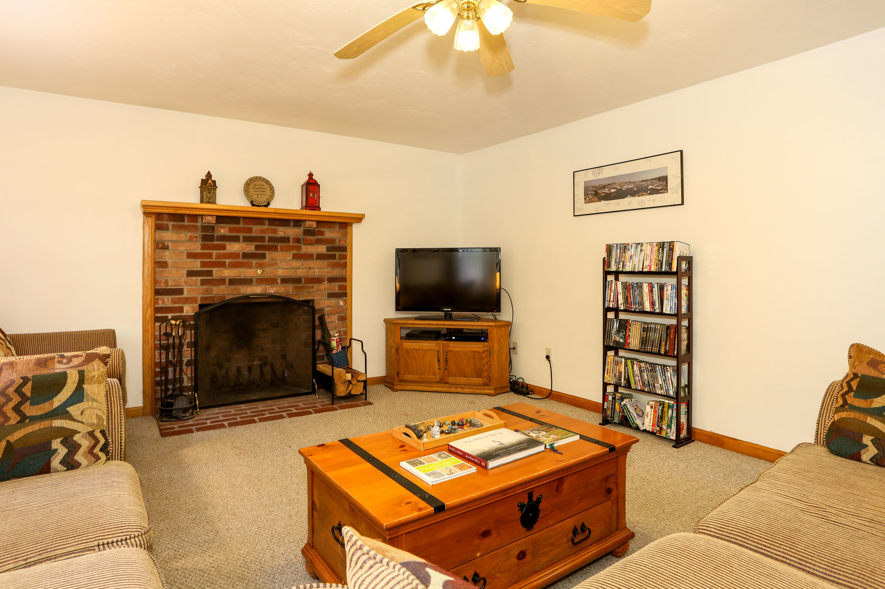 3 Andrew Road Sagamore Beach, MA 02562 - Photo 7 of 29 a living room with furniture a flat screen tv and a fireplace