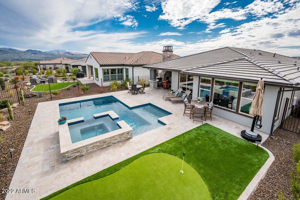 17860 East Cindercone Road Rio Verde, AZ 85263 - Photo 43 of 60 a front view of a house with swimming pool having outdoor seating