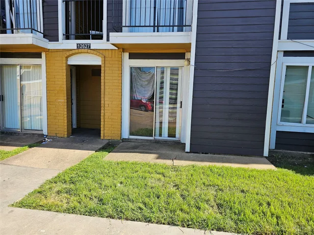a view of front door of house with yard