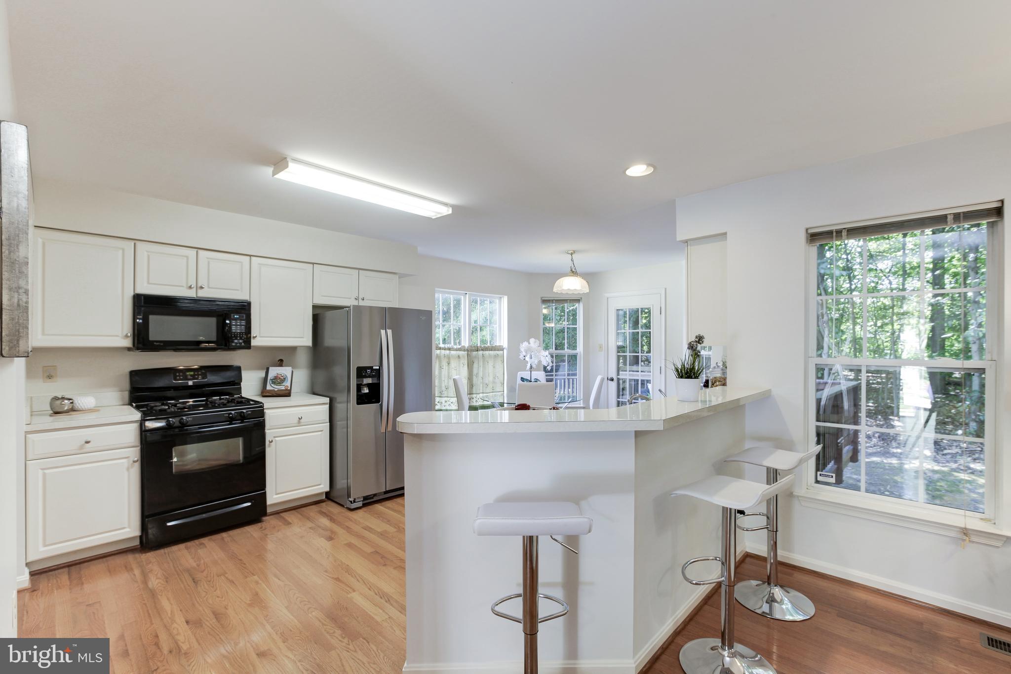 8014 Big Pool Road Laurel, MD 20724 - Photo 14 of 52 a kitchen with stainless steel appliances granite countertop a sink and a refrigerator