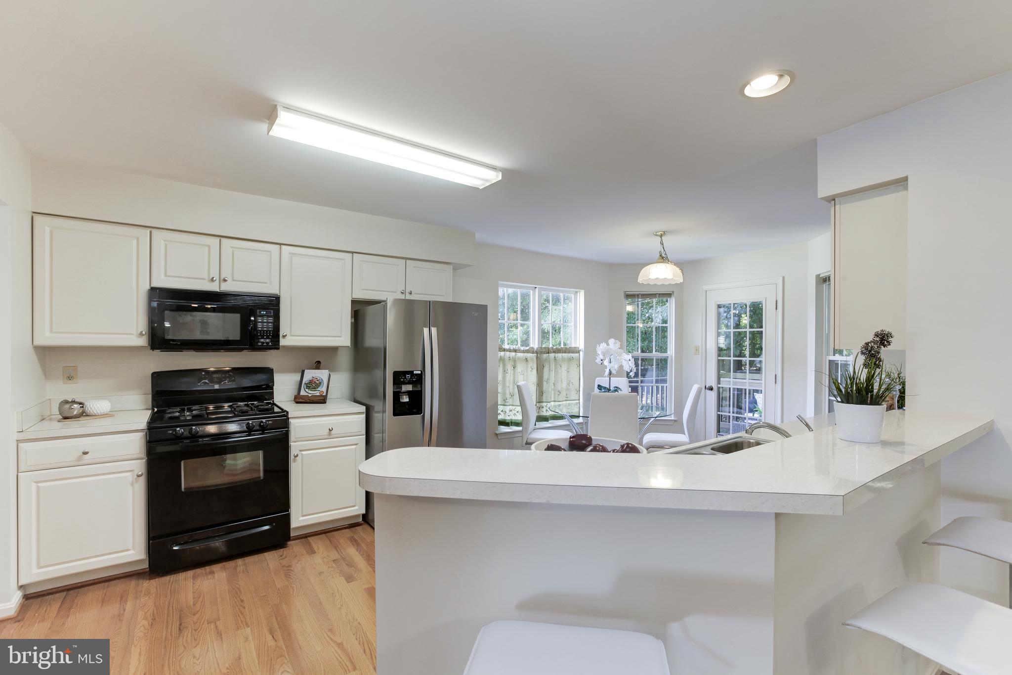 8014 Big Pool Road Laurel, MD 20724 - Photo 15 of 52 a kitchen with stainless steel appliances a sink and a refrigerator