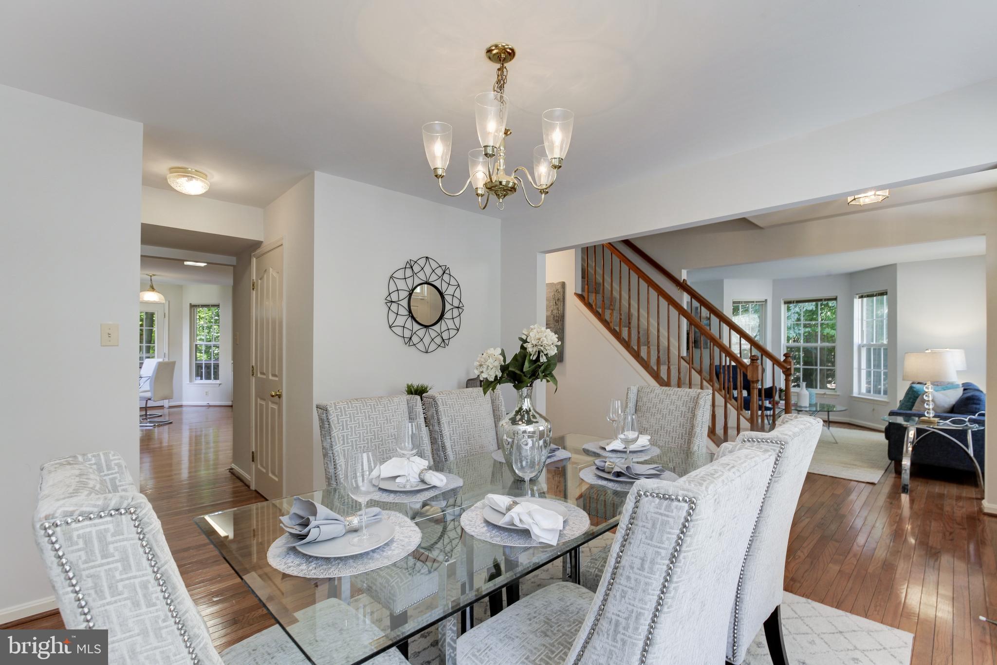 8014 Big Pool Road Laurel, MD 20724 - Photo 22 of 52 a view of a dining room with furniture a chandelier and wooden floor