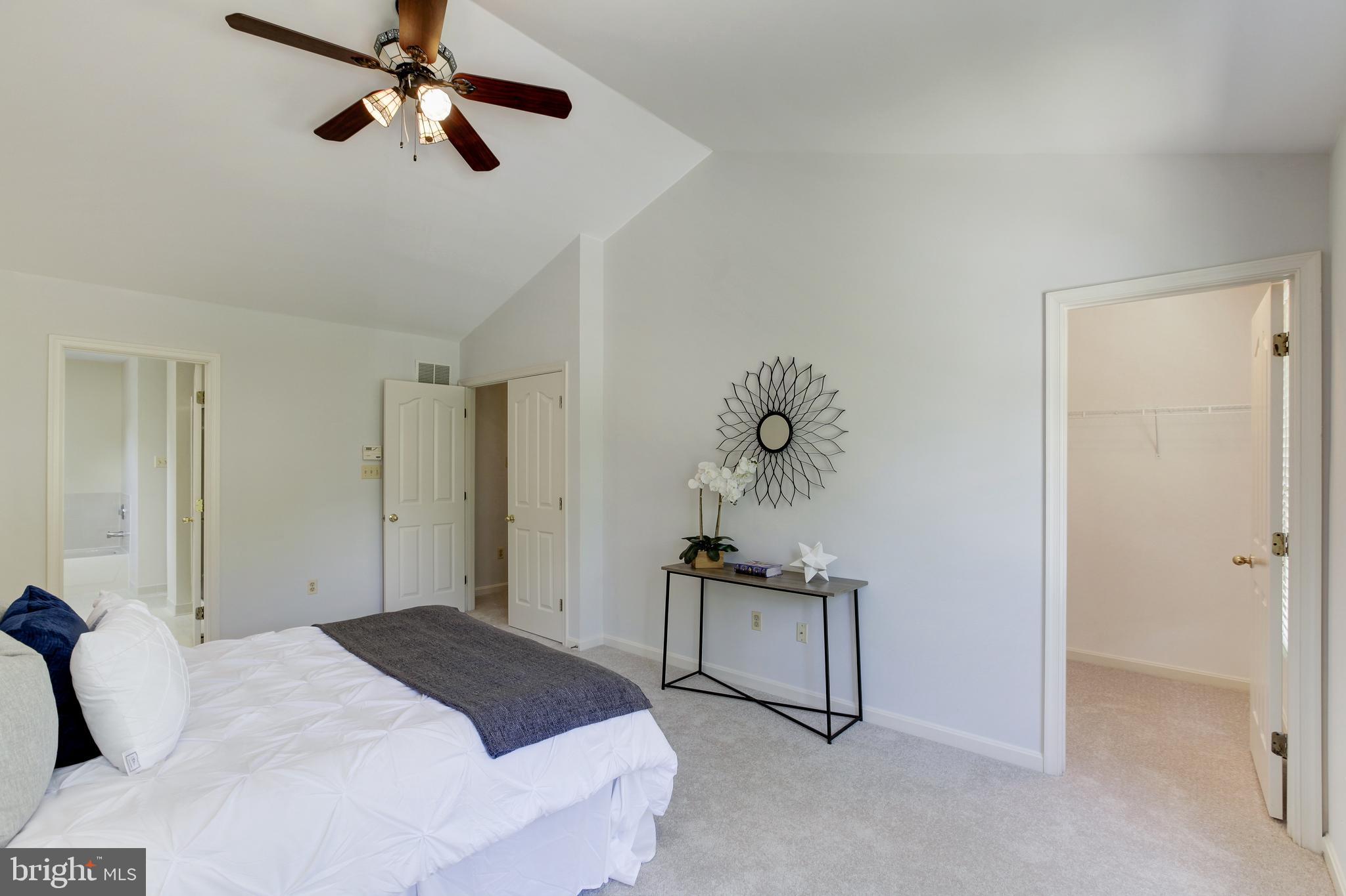 8014 Big Pool Road Laurel, MD 20724 - Photo 28 of 52 a bedroom with a bed and a chandelier