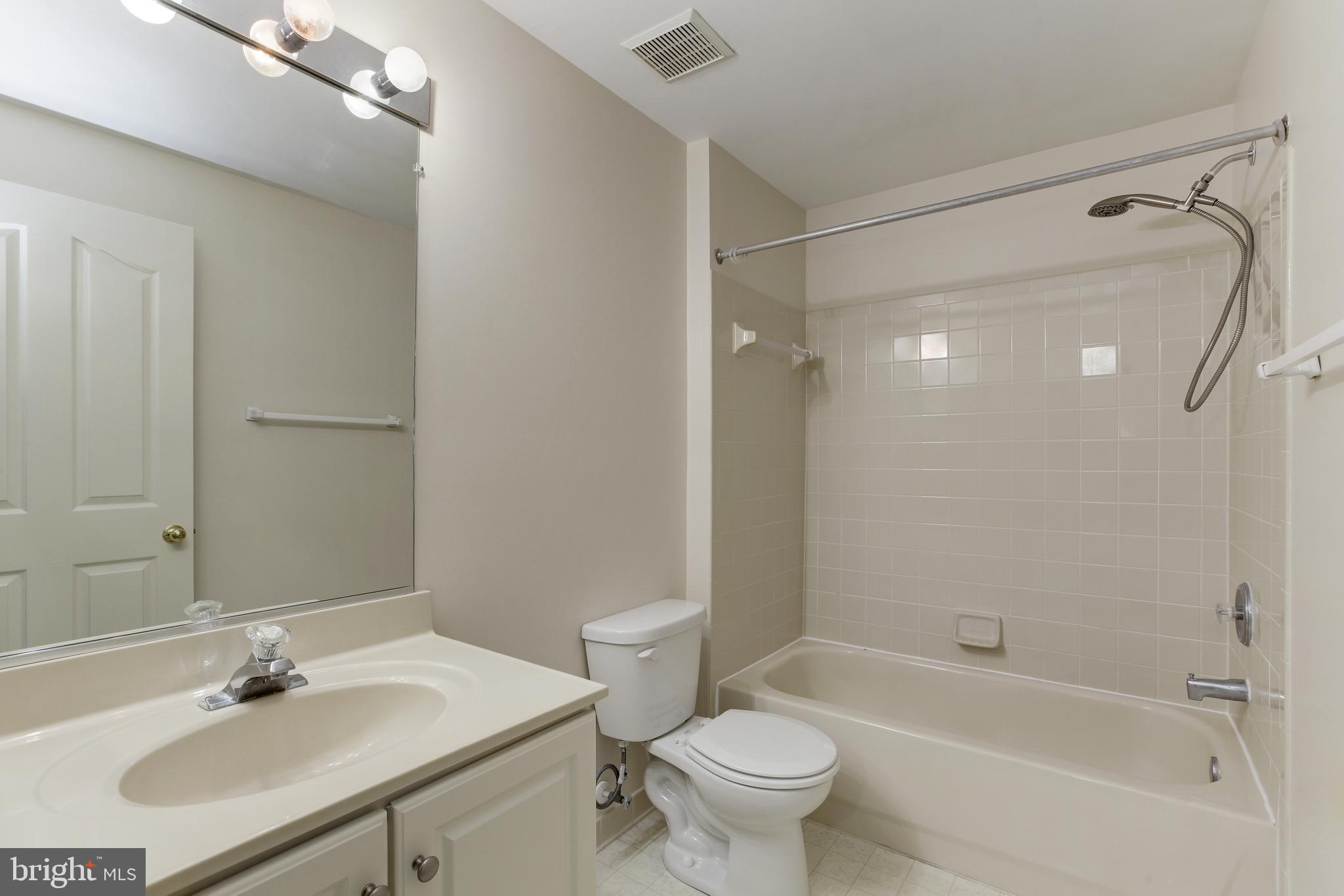8014 Big Pool Road Laurel, MD 20724 - Photo 43 of 52 a bathroom with a sink mirror toilet and bathtub