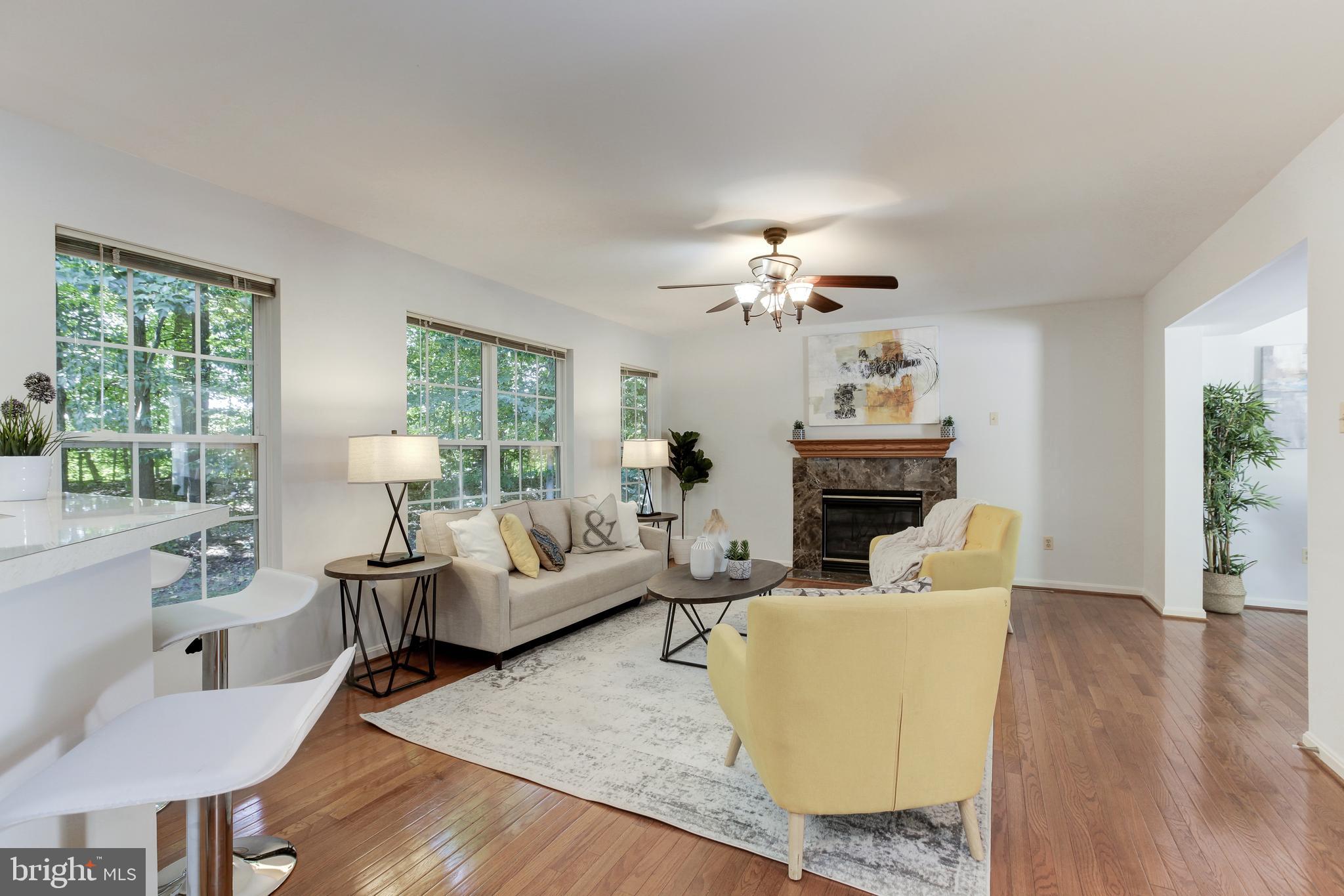 8014 Big Pool Road Laurel, MD 20724 - Photo 9 of 52 a living room with furniture a fireplace and a chandelier