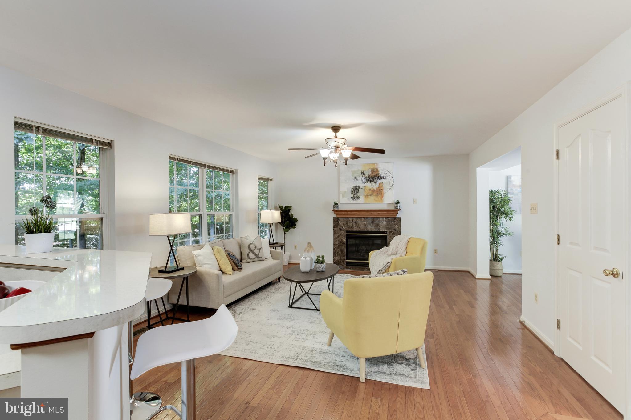 8014 Big Pool Road Laurel, MD 20724 - Photo 10 of 52 a living room with fireplace furniture and a wooden floor