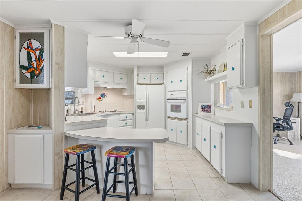 119 Lazy River Road North Port, FL 34287 - Photo 19 of 76 a kitchen with stainless steel appliances a sink and a refrigerator