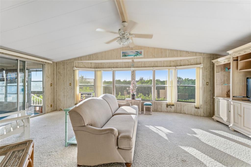 119 Lazy River Road North Port, FL 34287 - Photo 26 of 76 a living room with furniture and large windows