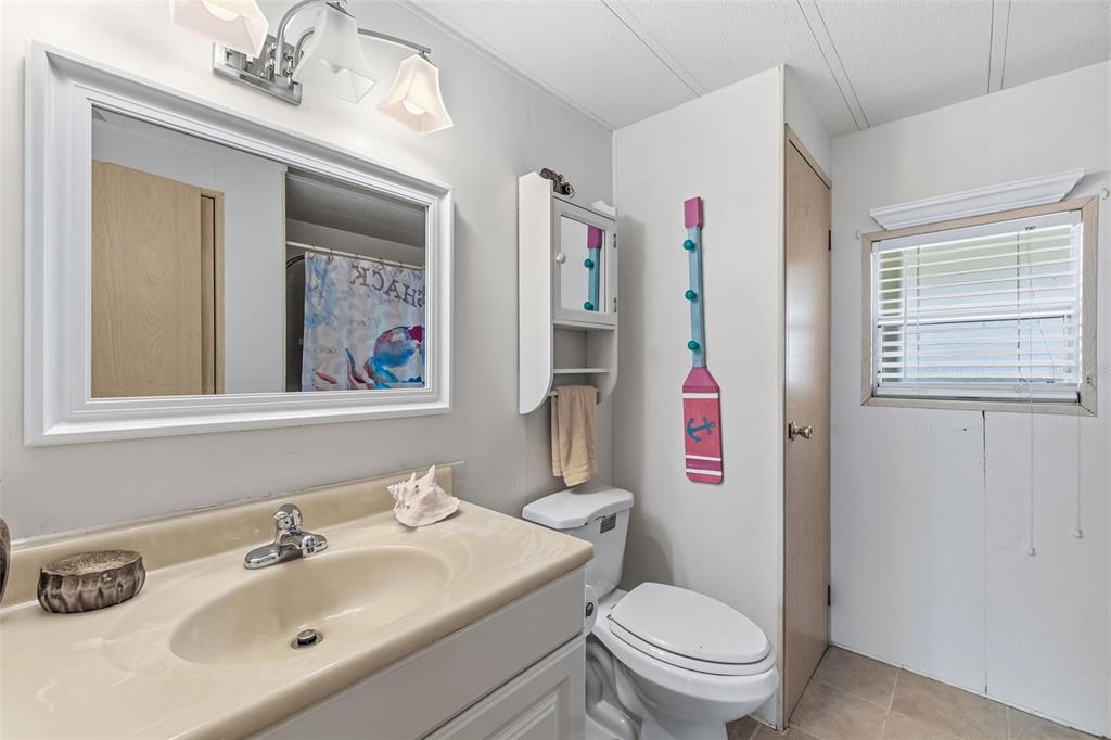 119 Lazy River Road North Port, FL 34287 - Photo 38 of 76 a bathroom with a sink a toilet and a mirror