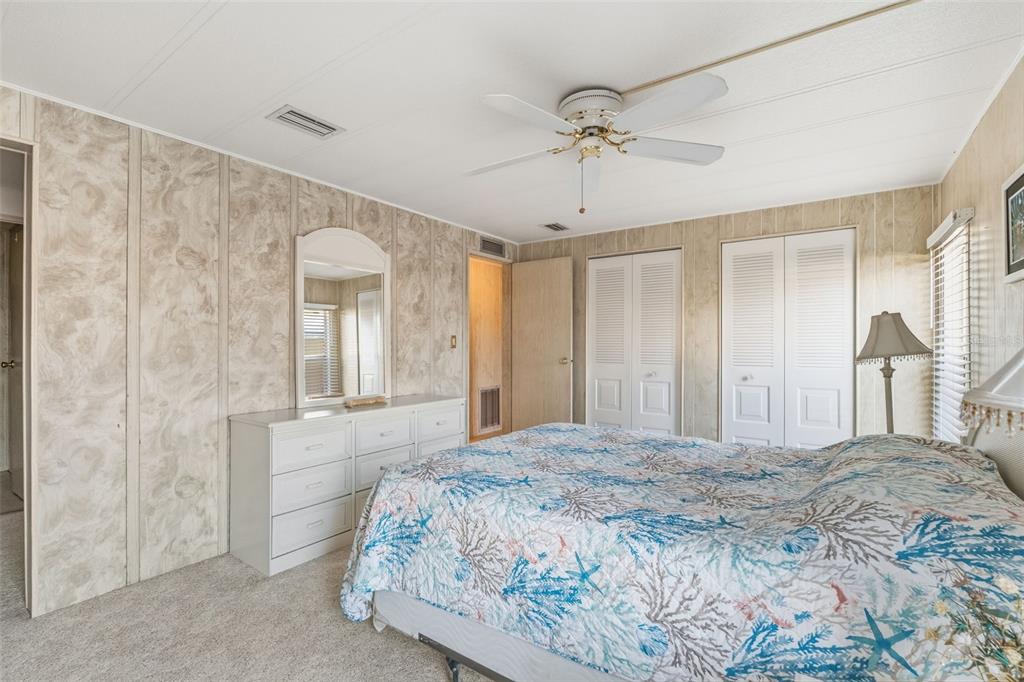 119 Lazy River Road North Port, FL 34287 - Photo 41 of 76 a bedroom with a large bed and a chandelier