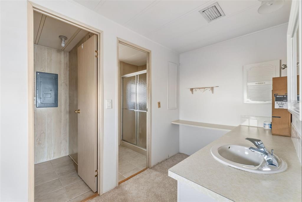 119 Lazy River Road North Port, FL 34287 - Photo 42 of 76 a bathroom with a sink and a mirror