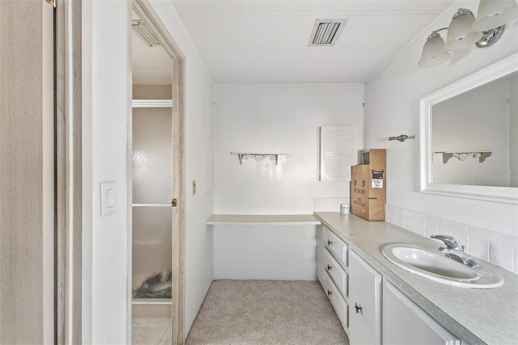 119 Lazy River Road North Port, FL 34287 - Photo 43 of 76 a bathroom with a double vanity sink a mirror and a bathtub
