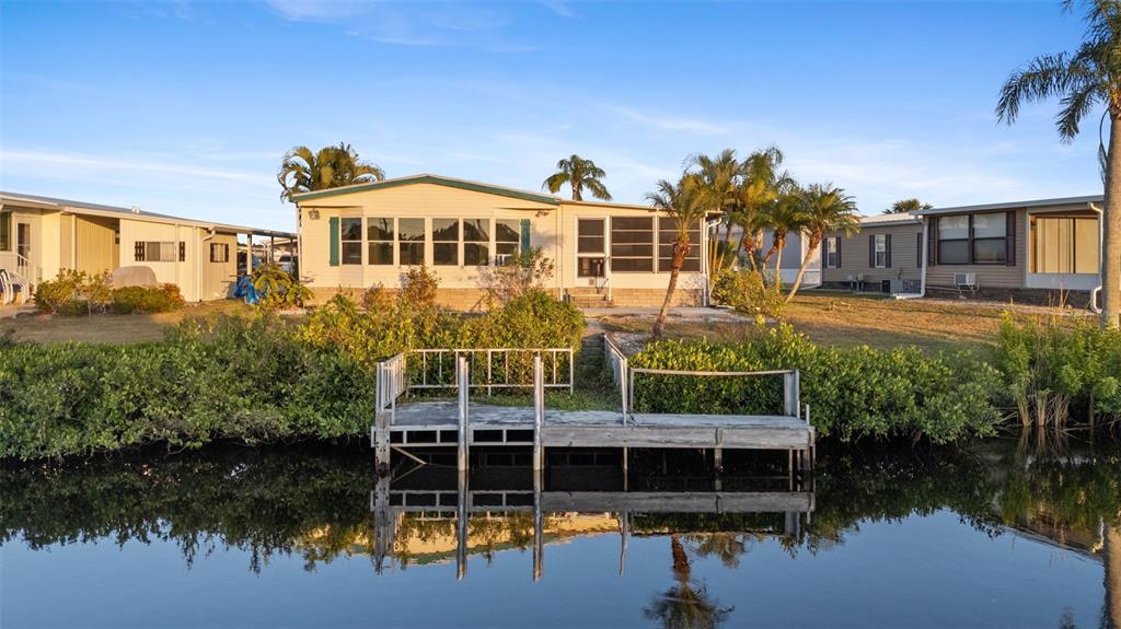 119 Lazy River Road North Port, FL 34287 - Photo 8 of 76 a front view of a house with a yard