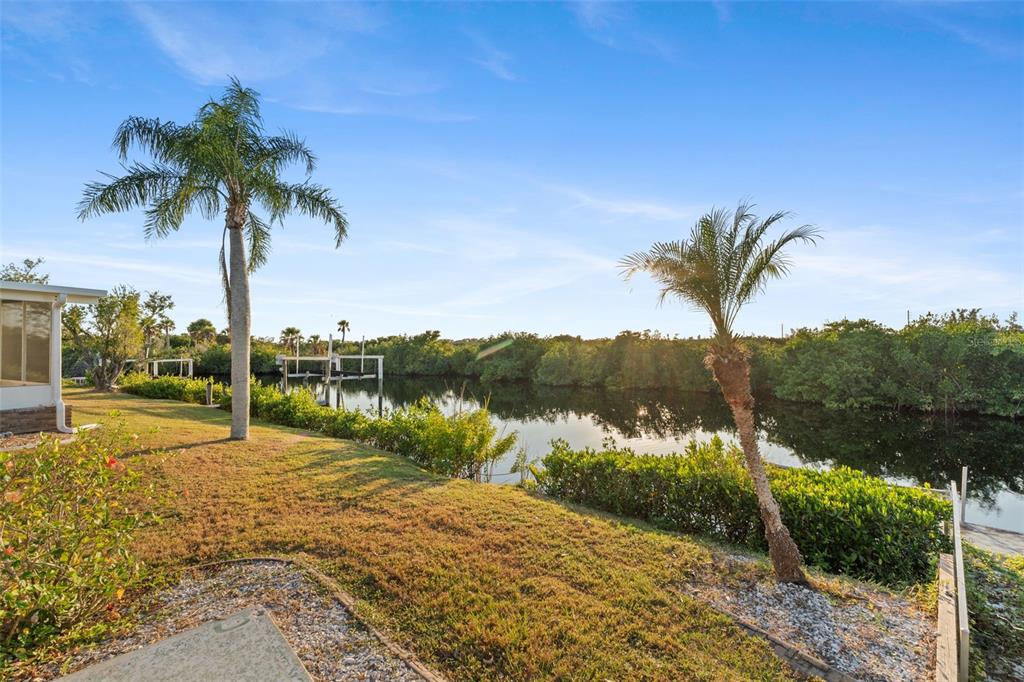 119 Lazy River Road North Port, FL 34287 - Photo 9 of 76 a view of a lake with a yard