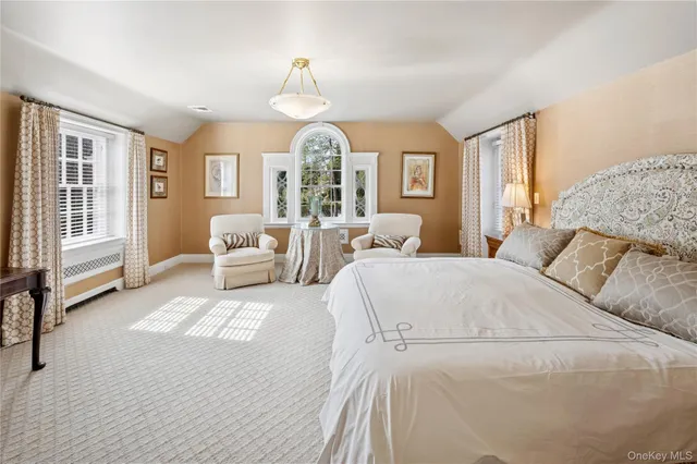 a bedroom with a large bed and a window