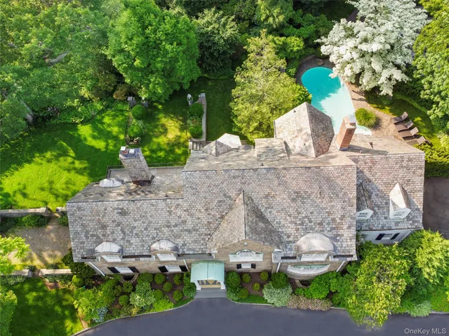 an aerial view of a house with a yard and garden