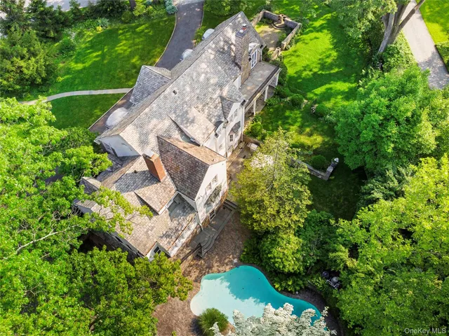 an aerial view of a house with a yard