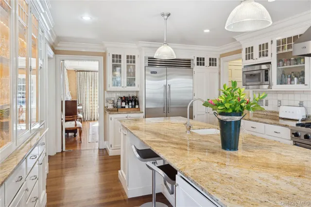 a kitchen with stainless steel appliances granite countertop sink stove and wooden floor
