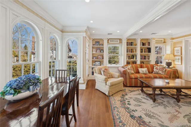 a living room with furniture and floor to ceiling windows