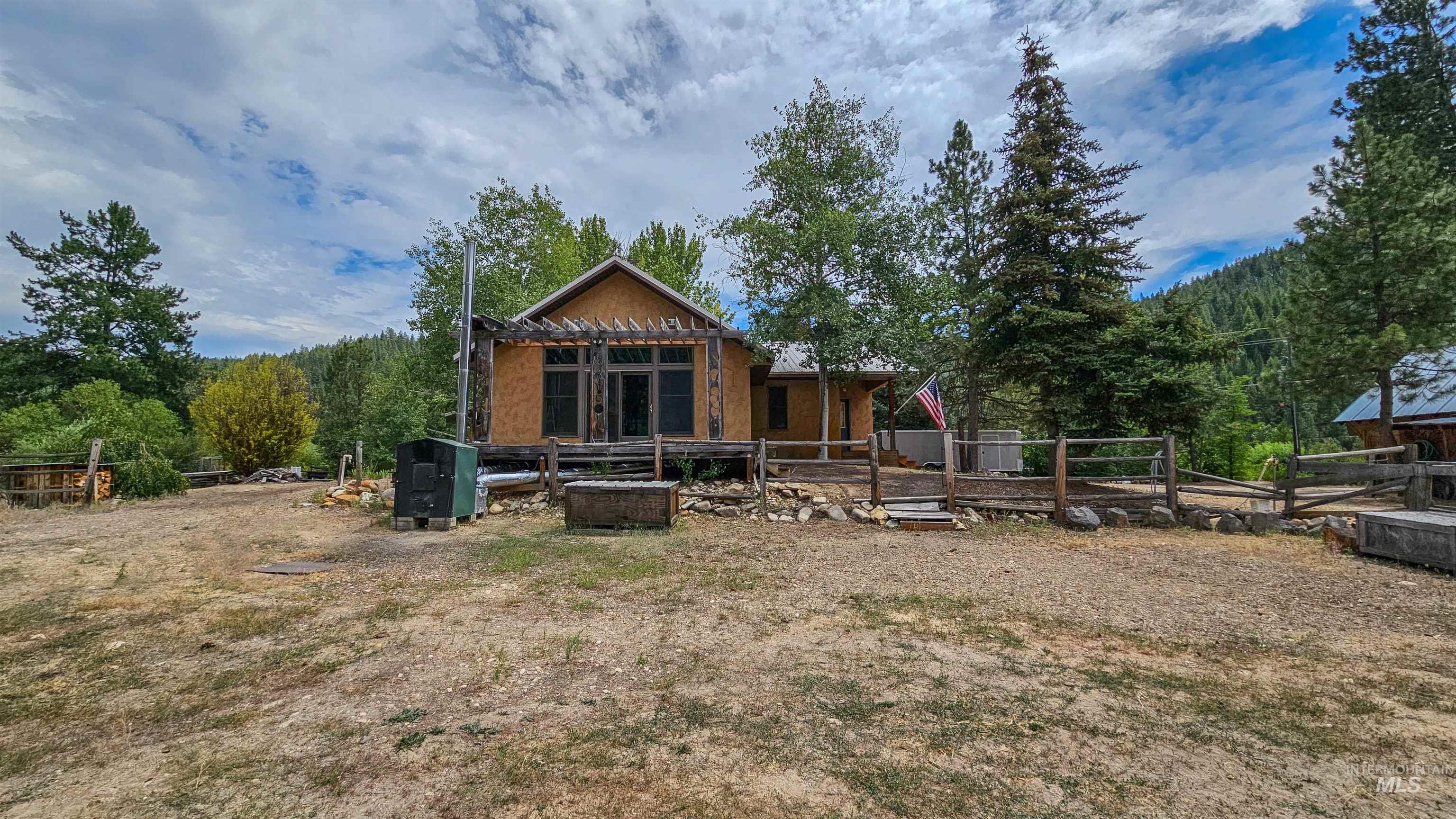 3382 Highway 21 Boise, ID 83716 - Photo 28 of 50 Rear view of property with a wooded view and a wooden deck