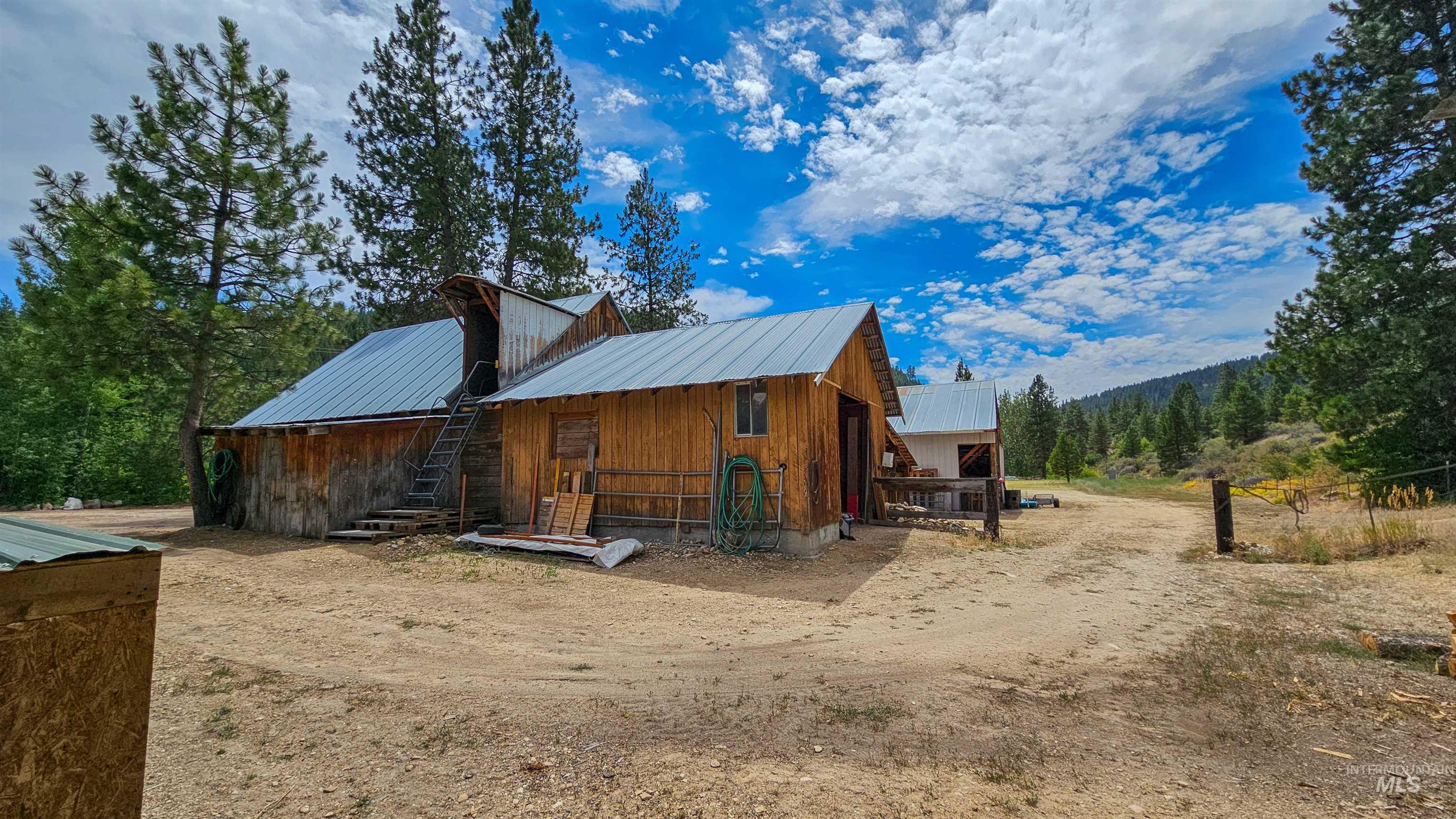 3382 Highway 21 Boise, ID 83716 - Photo 40 of 50 View of property exterior with a metal roof, an outdoor structure, board and batten siding, and an exterior structure