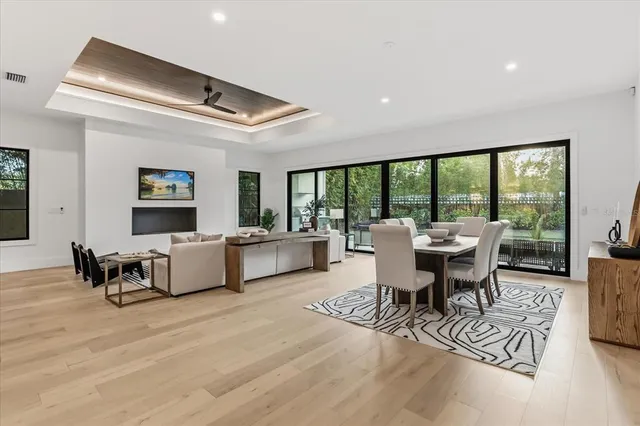 a living room with furniture a flat screen tv and kitchen view