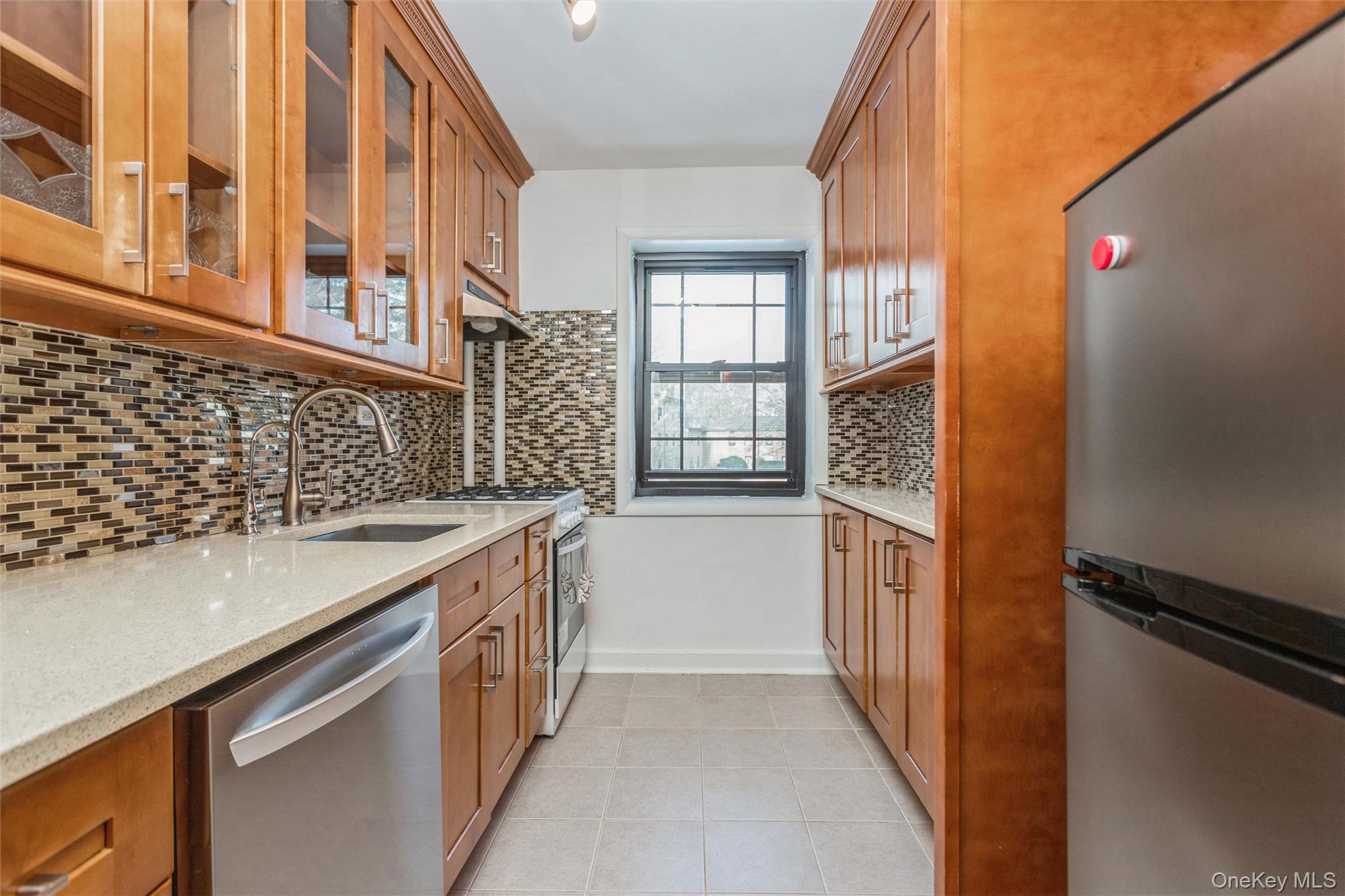 25 Manchester Road, Unit B23 Eastchester, NY 10709 - Photo 10 of 28 a kitchen with a sink and a refrigerator
