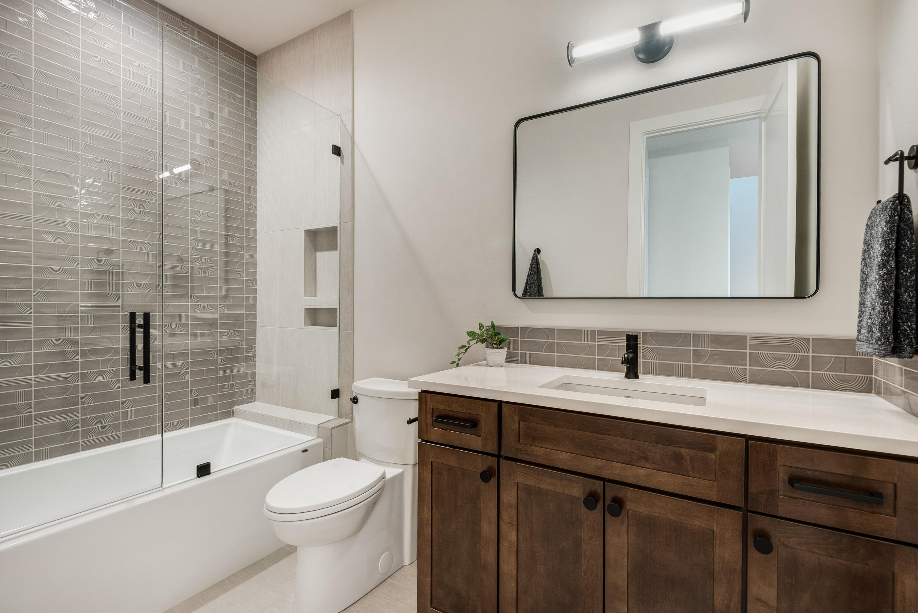 334 Southwest Roosevelt Avenue, Unit 4 Bend, OR 97702 - Photo 17 of 22 a bathroom with a toilet a sink a tub and mirror