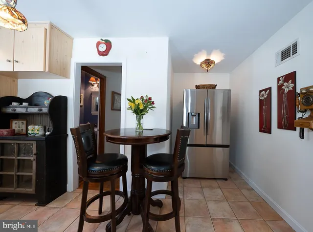 a spacious bedroom with a bed and wooden floor