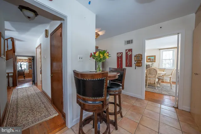 a spacious bedroom with a bed and wooden floor